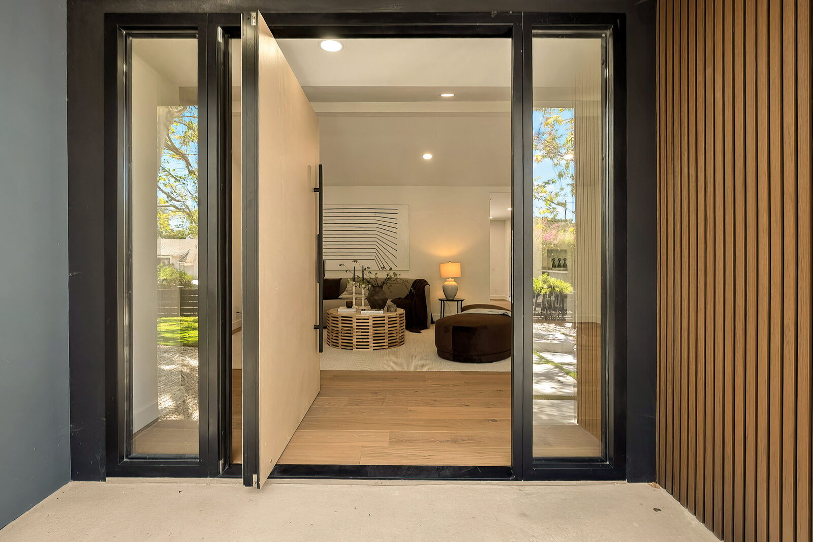 Pivot entry door with two sidelights at the completed Hartsook Street home