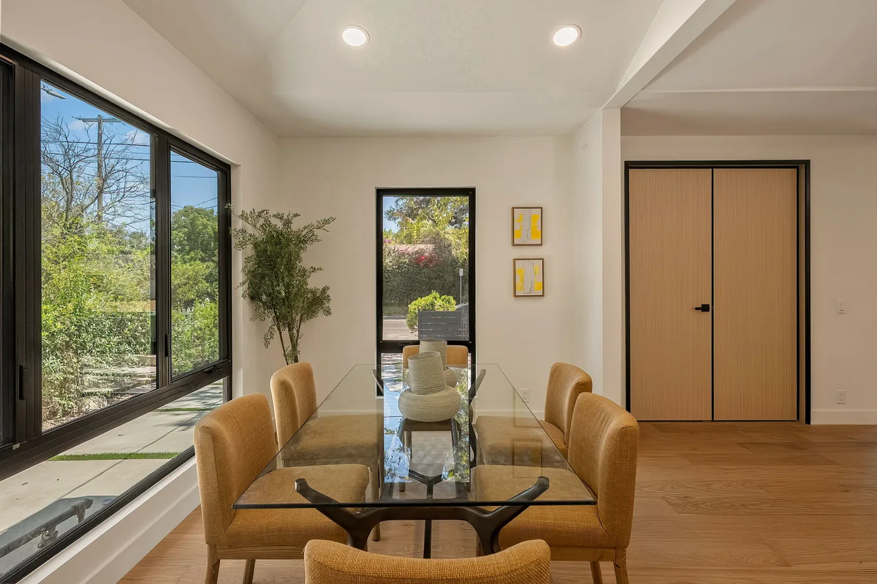 Black-framed windows alongside the dining area.