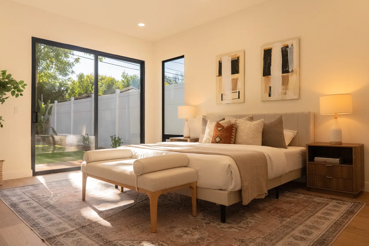 A wide sliding glass opening from the bedroom to the garden.