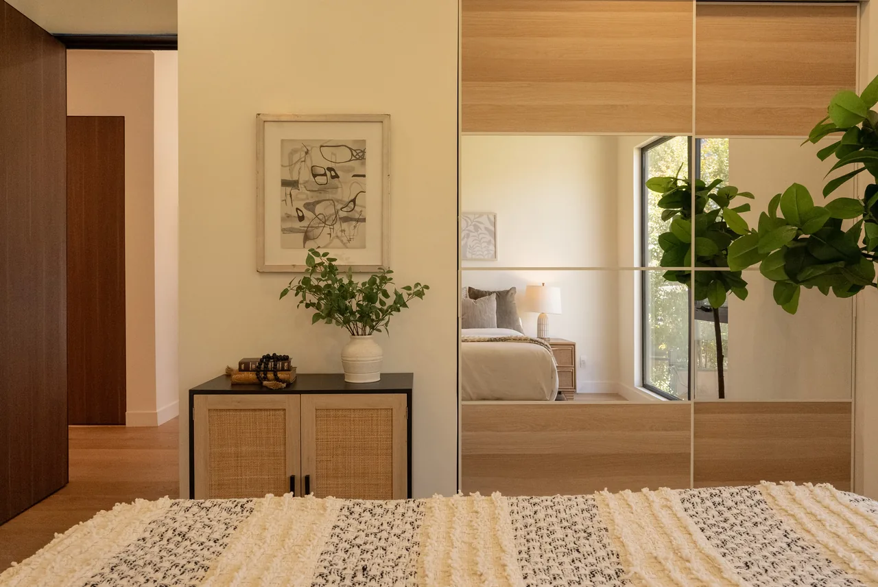 Wide sliding closet doors with mirrored panels.