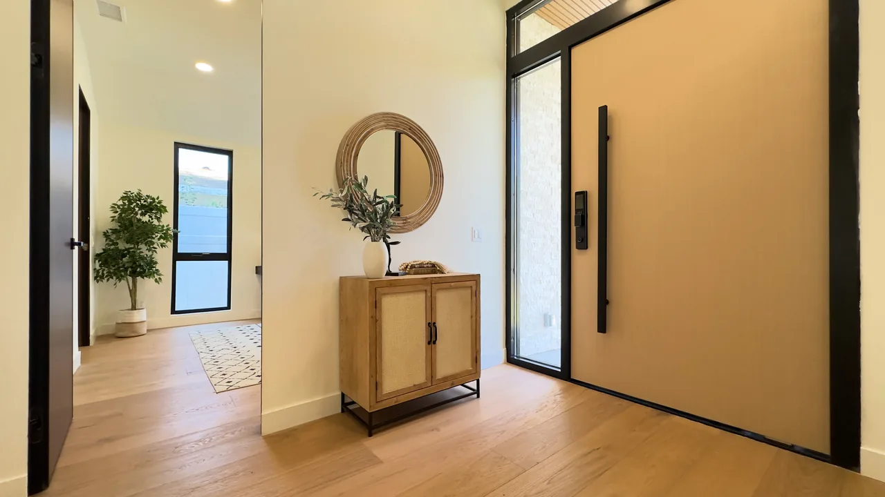 The entry door, tall pull and sidelight seen from inside the home.