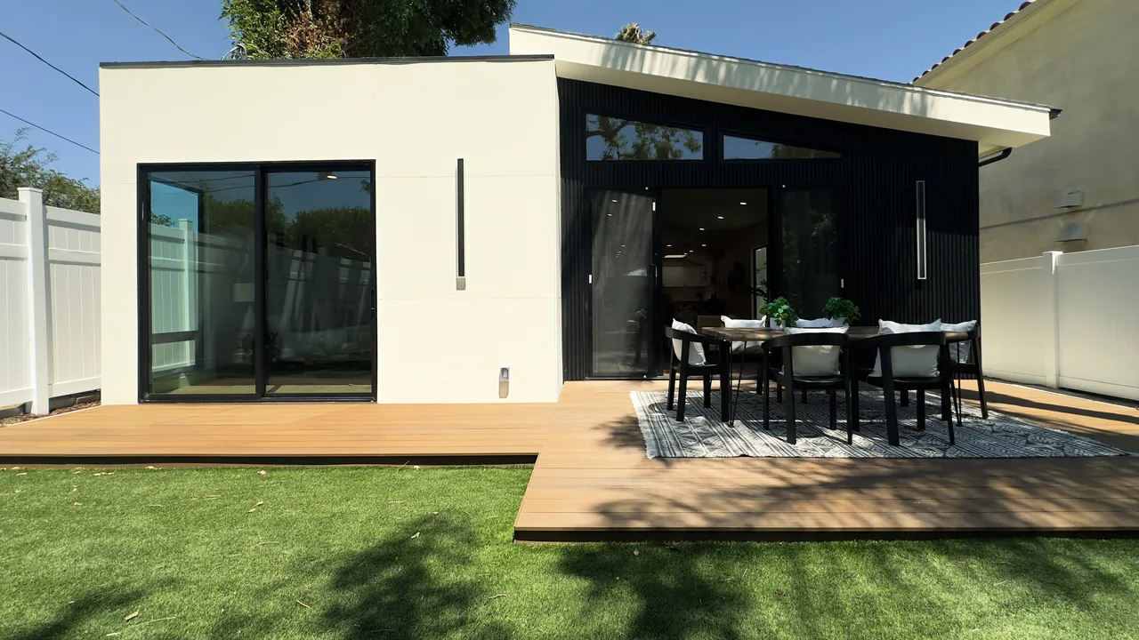 The rear glazed openings and terrace in the completed home.