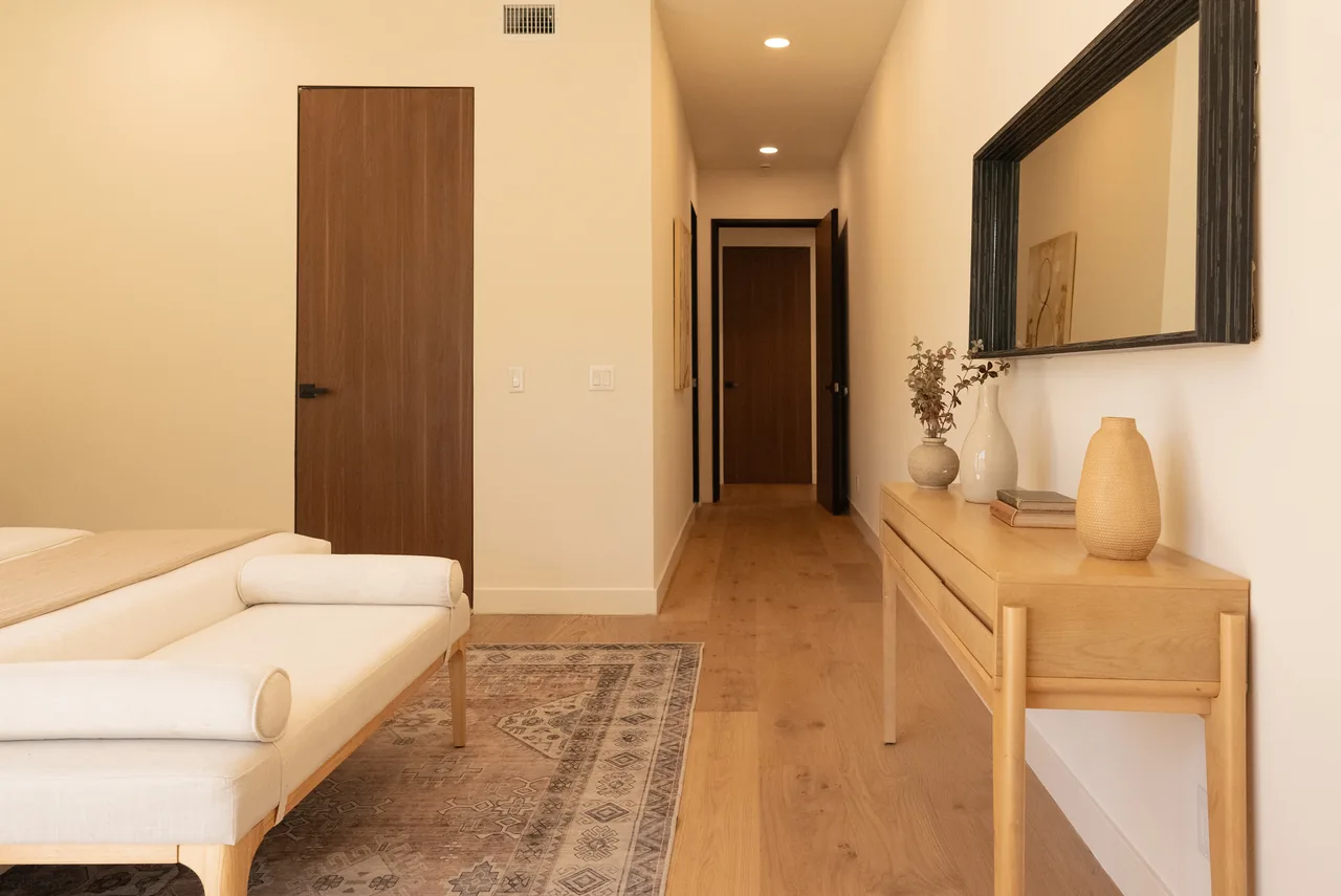 Wood-toned doors connecting the bedroom and hallway.