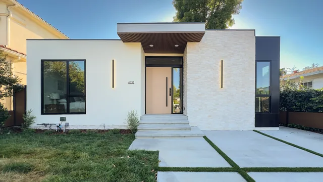The completed Norwich Avenue home with its entry door, sidelight and front windows